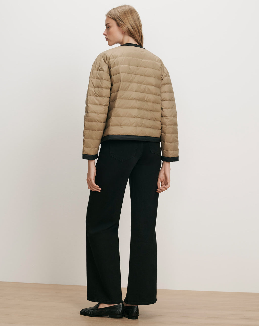 Veronica Beard Tan quilted jacket with black trim.