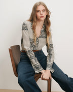 Veronica Beard Patterned silk button-up shirt and dark wash jeans.