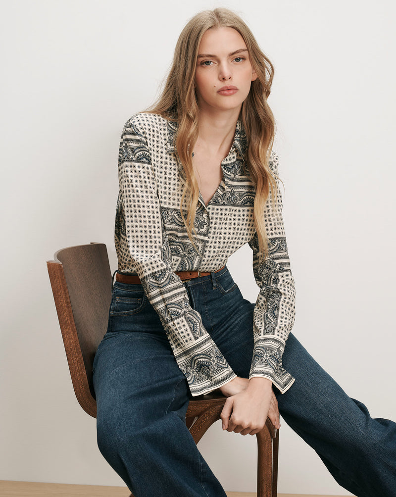 Veronica Beard Patterned silk button-up shirt and dark wash jeans.