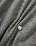 Veronica Beard Gray knit sweater with pearl and gold button details.