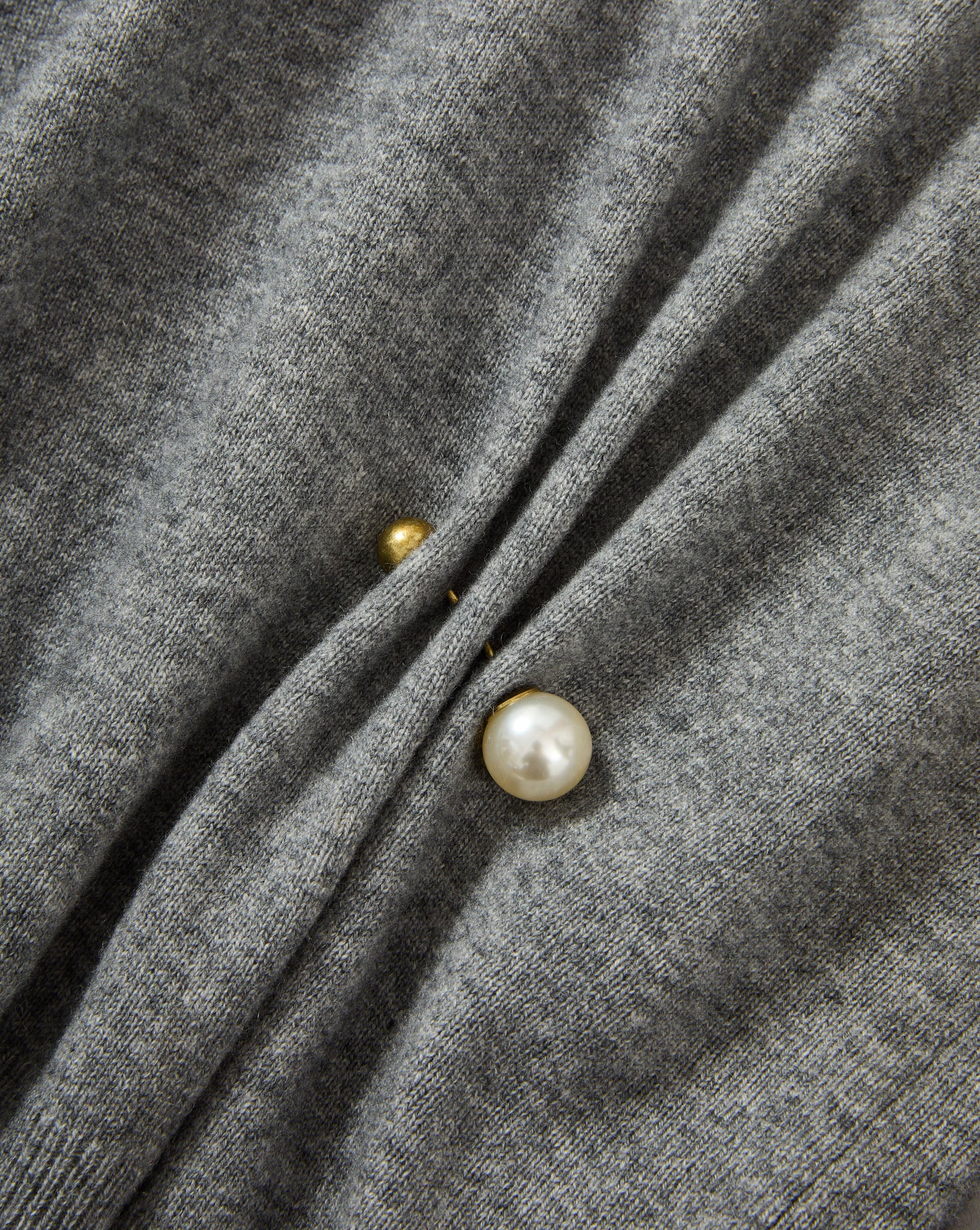 Veronica Beard Gray knit sweater with pearl and gold button details.