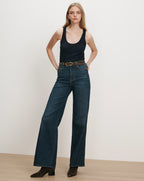 Veronica Beard Black ribbed tank top, dark wash wide-leg jeans.
