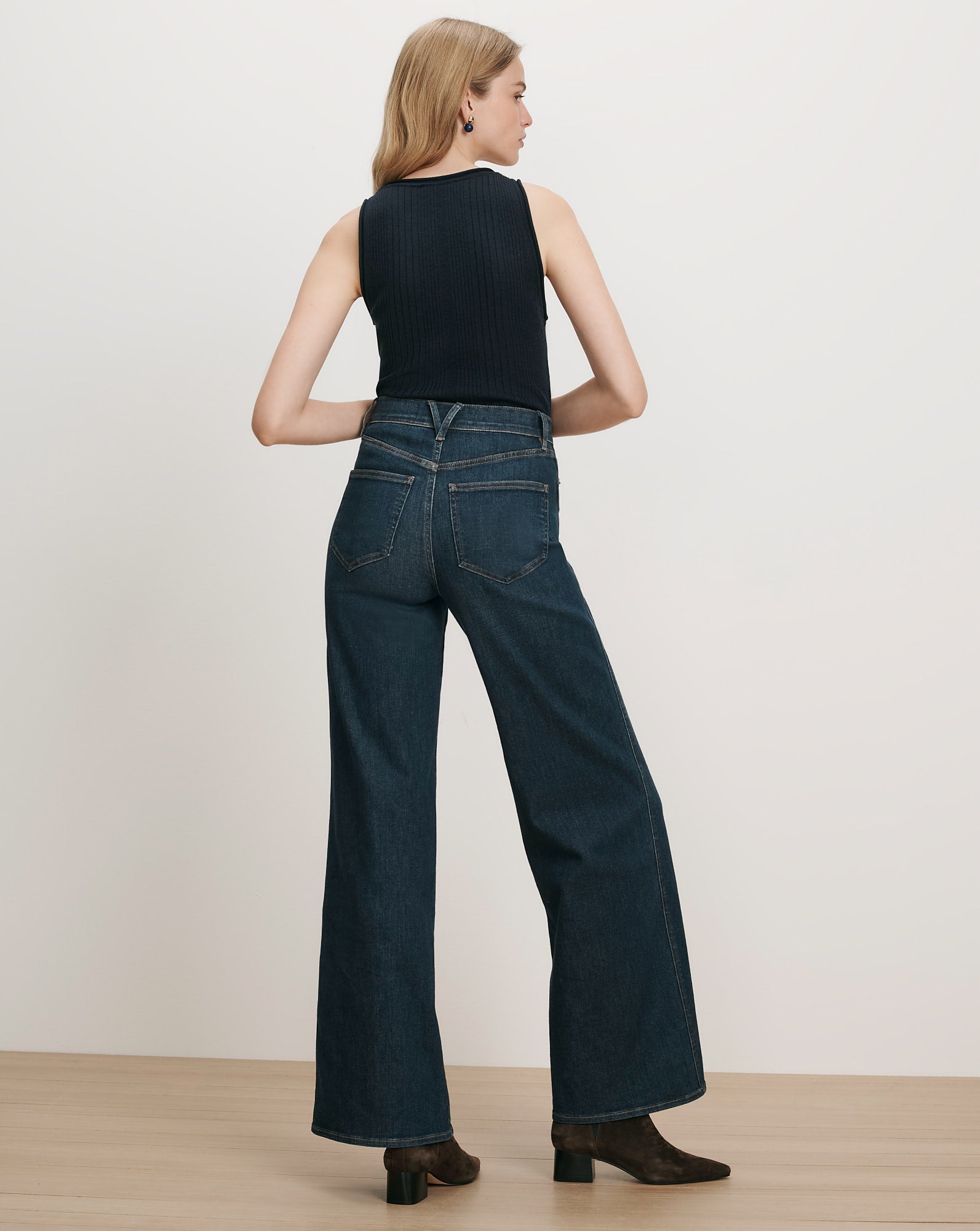 Veronica Beard Dark wash wide-leg jeans and black ribbed tank top.