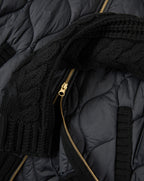 Veronica Beard Black quilted jacket with gold zipper and knit trim.