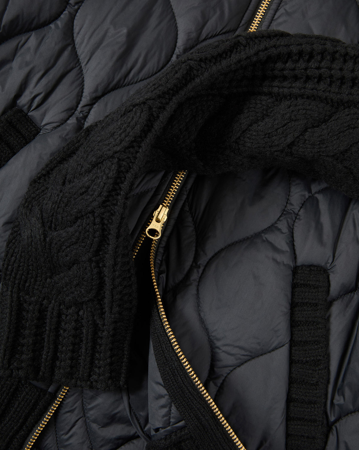 Veronica Beard Black quilted jacket with gold zipper and knit trim.