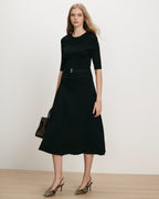 Veronica Beard Black ribbed knit midi dress with pleated skirt.