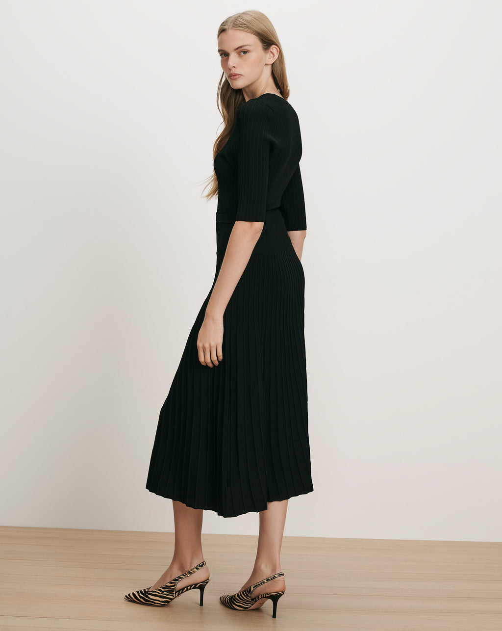 Veronica Beard Black ribbed knit midi dress with pleated skirt.