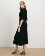 Veronica Beard Black ribbed knit midi dress with pleated skirt.
