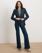 Veronica Beard Navy pinstripe blazer, gray sweater, dark wash jeans.