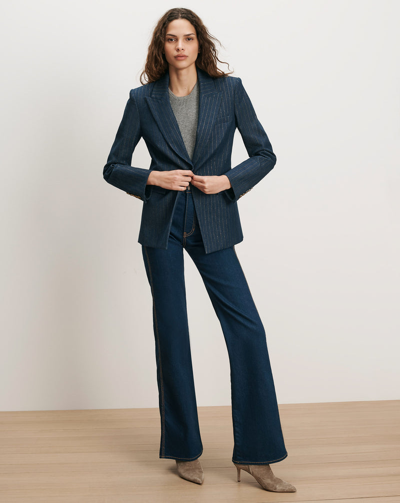 Veronica Beard Dark wash flared jeans and a striped jacket.