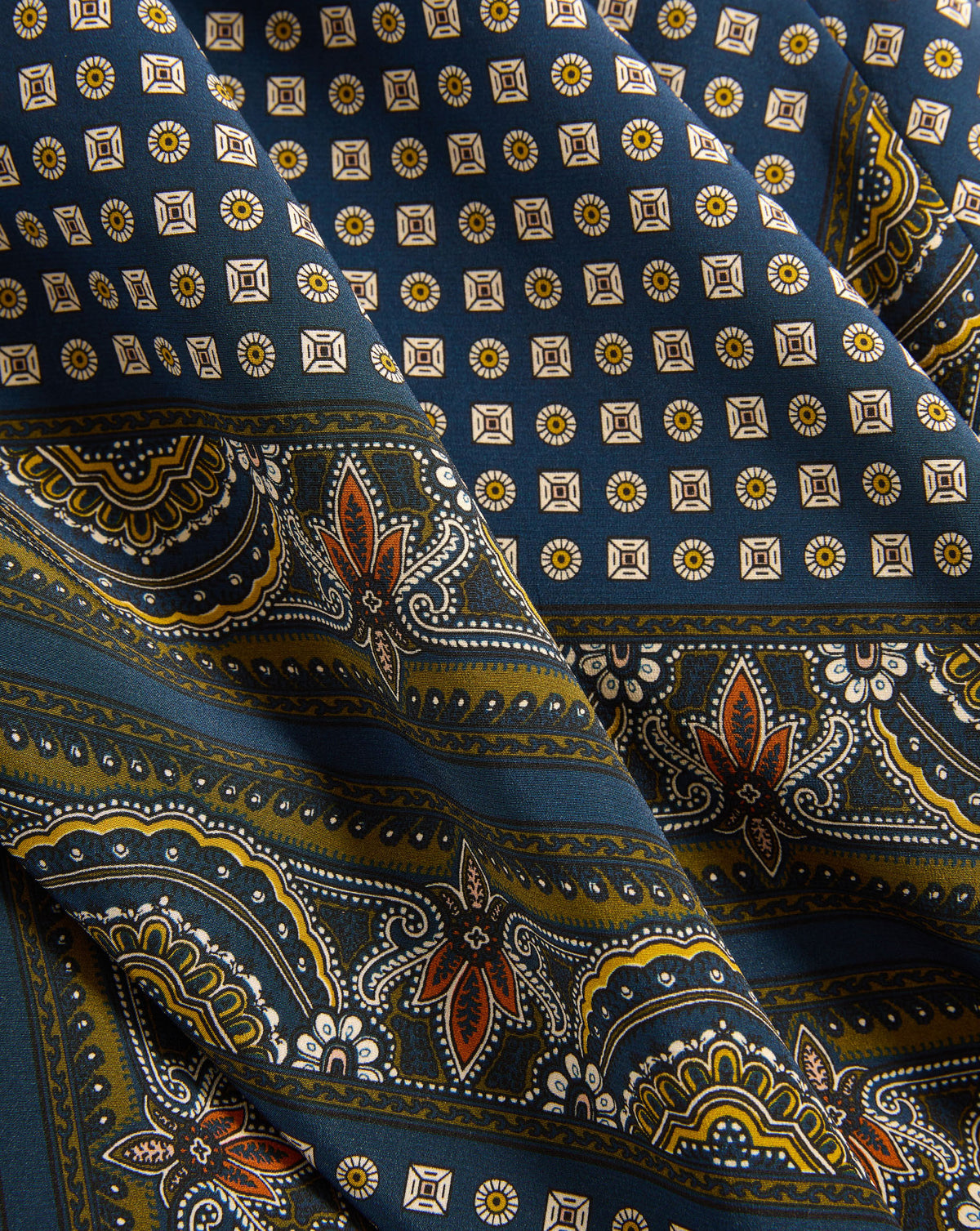Veronica Beard Blue silk scarf with geometric and paisley patterns.