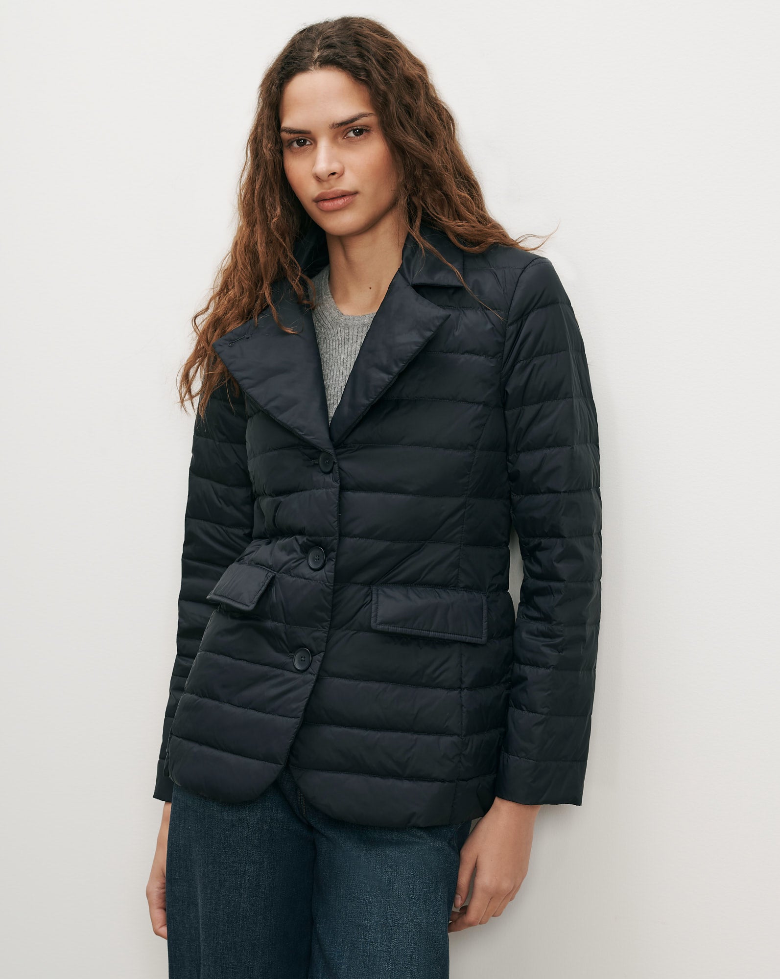 Veronica Beard Navy quilted blazer with notched lapels and flap pockets.