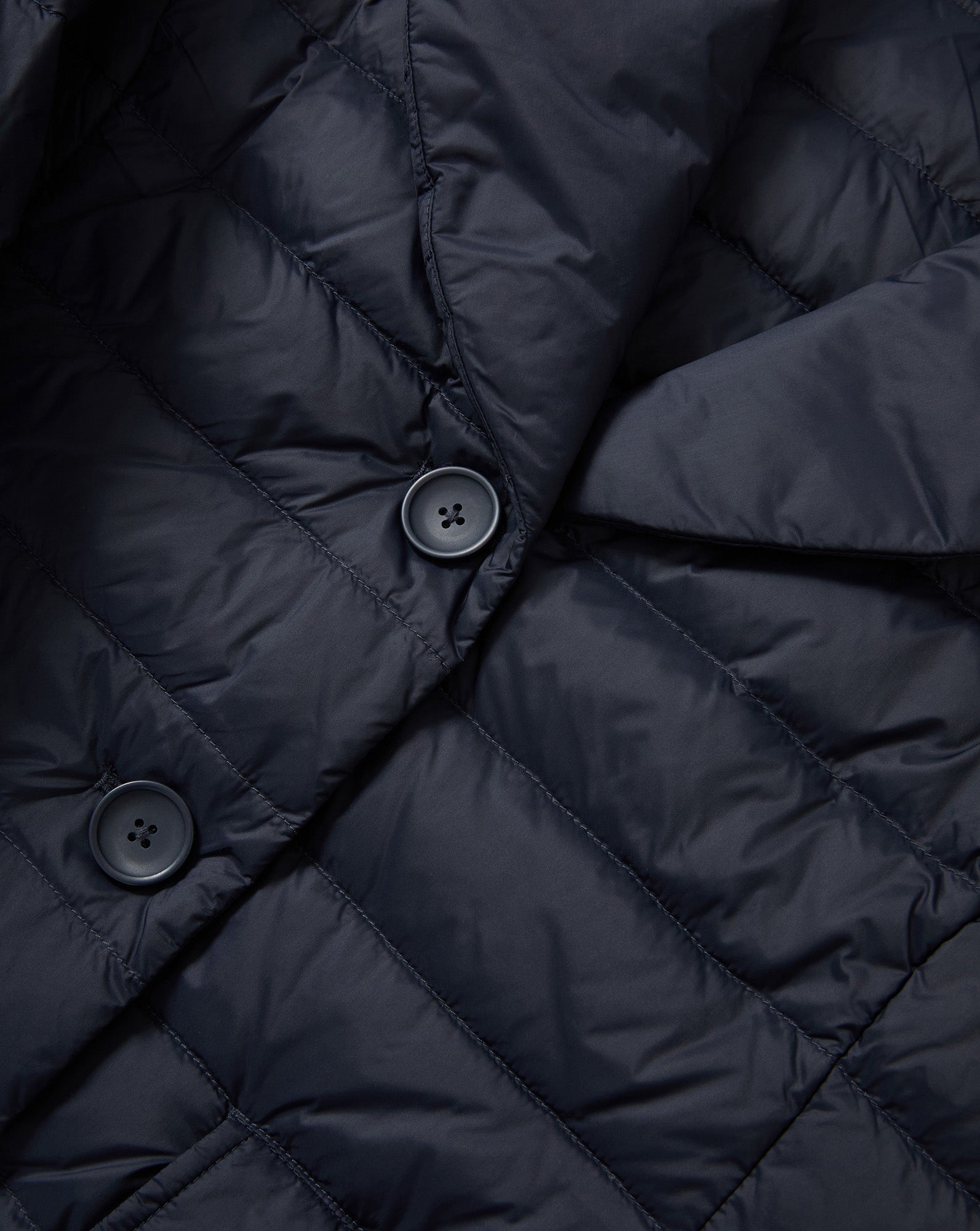 Veronica Beard Navy quilted puffer jacket with black buttons.