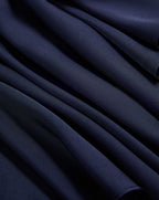 Veronica Beard Navy blue pleated fabric with soft folds.