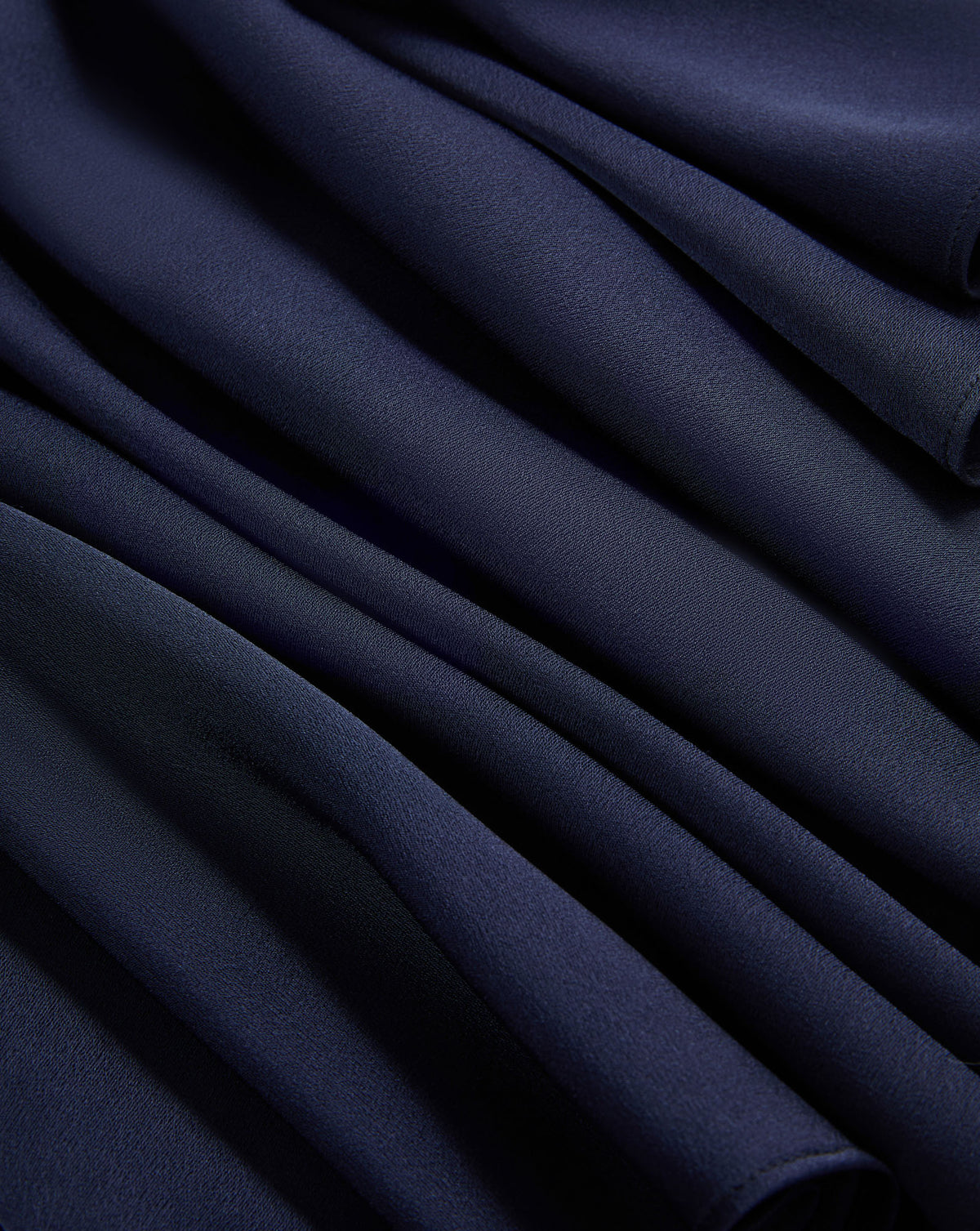 Veronica Beard Navy blue pleated fabric with soft folds.