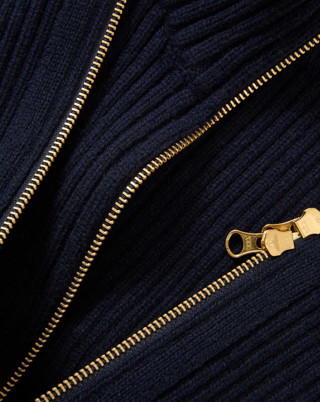 Veronica Beard Navy ribbed knit sweater with gold zipper.