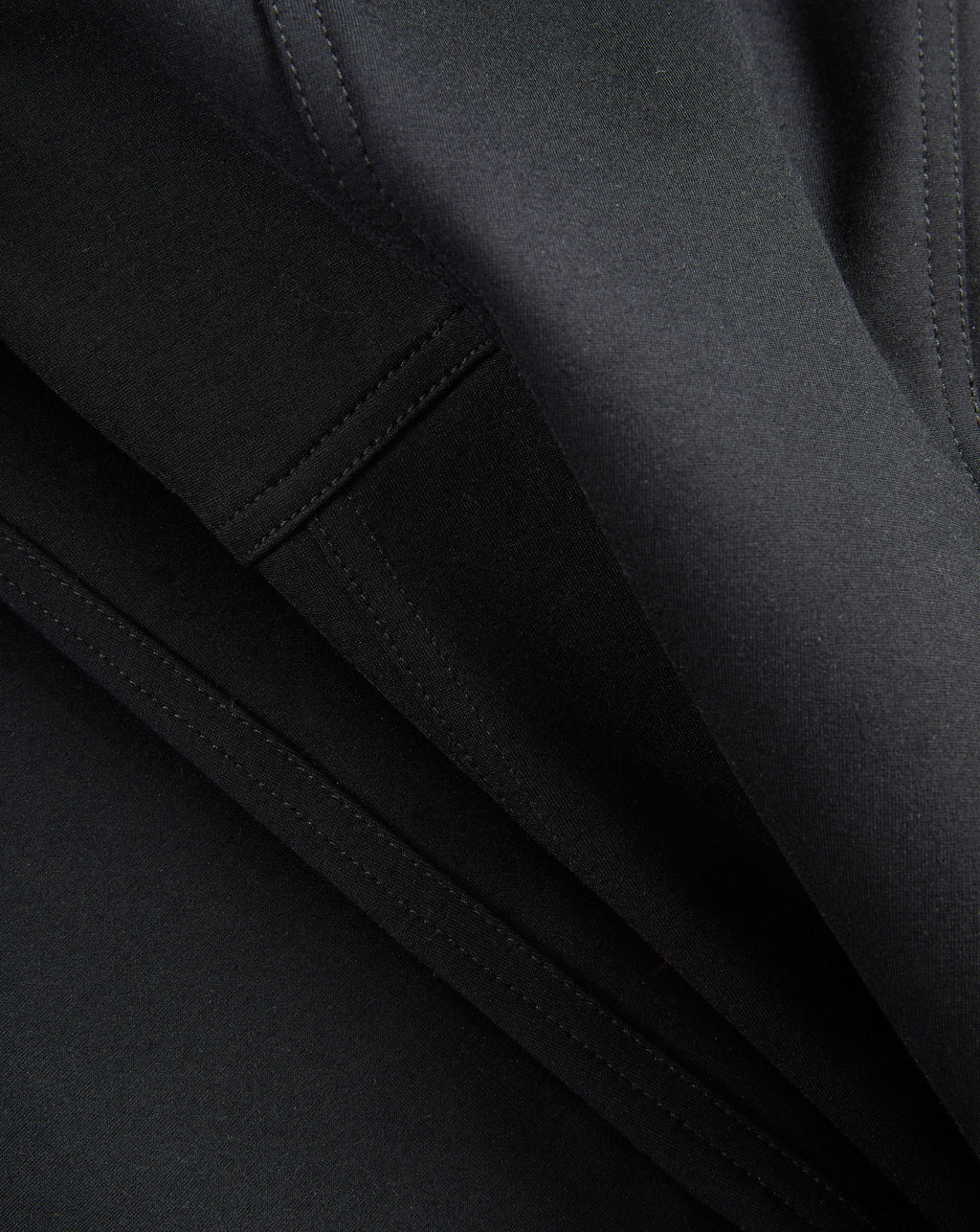 Veronica Beard Black fabric with visible stitching and folds.