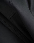 Veronica Beard Black fabric with visible stitching and folds.