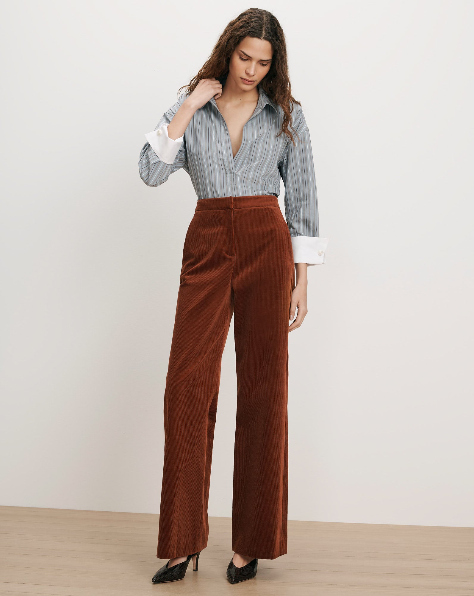 Veronica Beard Brown corduroy wide-leg pants and striped button-up shirt.