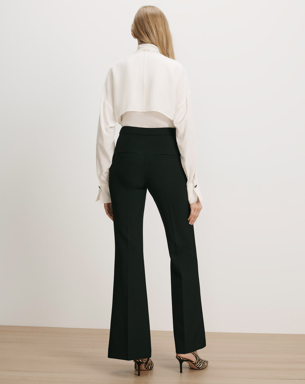 Veronica Beard Black flared trousers, white silk blouse.