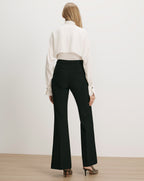 Veronica Beard Black flared trousers, white silk blouse.