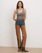 Veronica Beard Multicolor knit tank top and blue jeans with brown suede chaps.