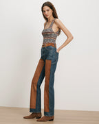 Veronica Beard Blue jeans with brown suede chaps and a striped tank top.