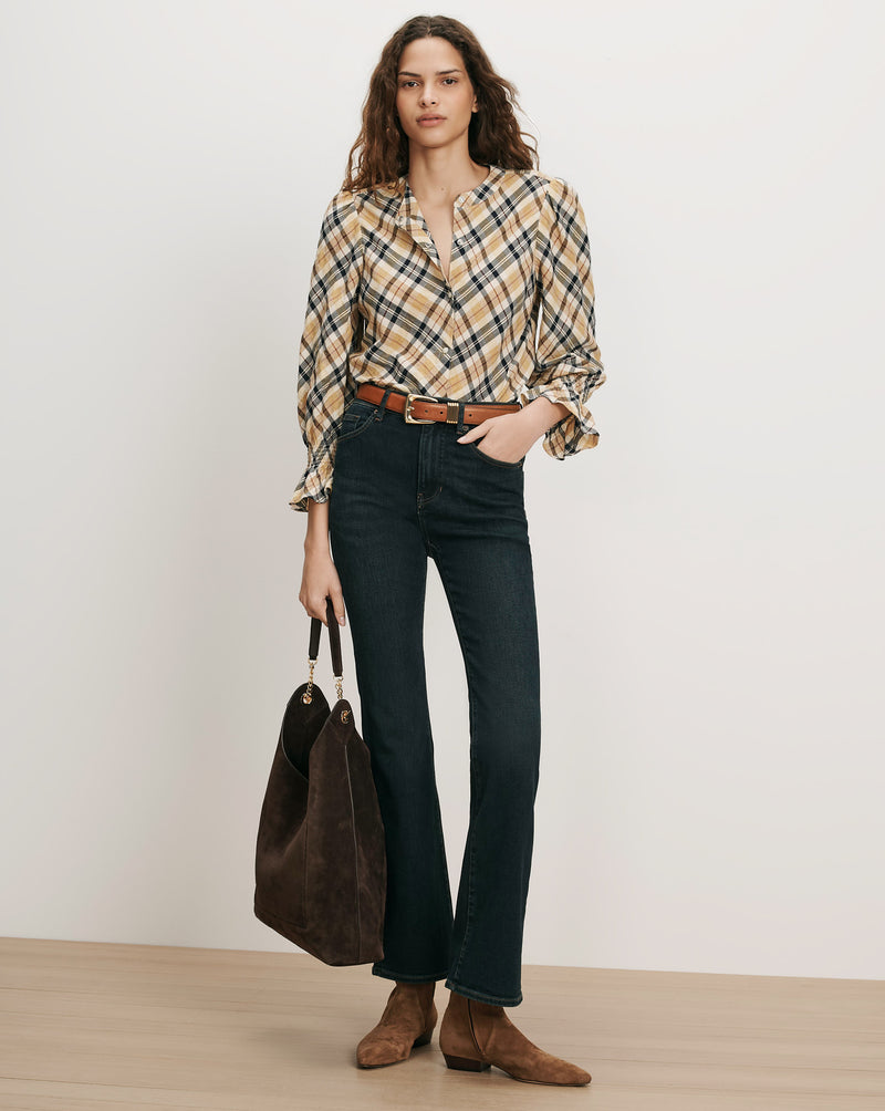 Veronica Beard Plaid blouse, dark jeans, brown belt, and suede bag.