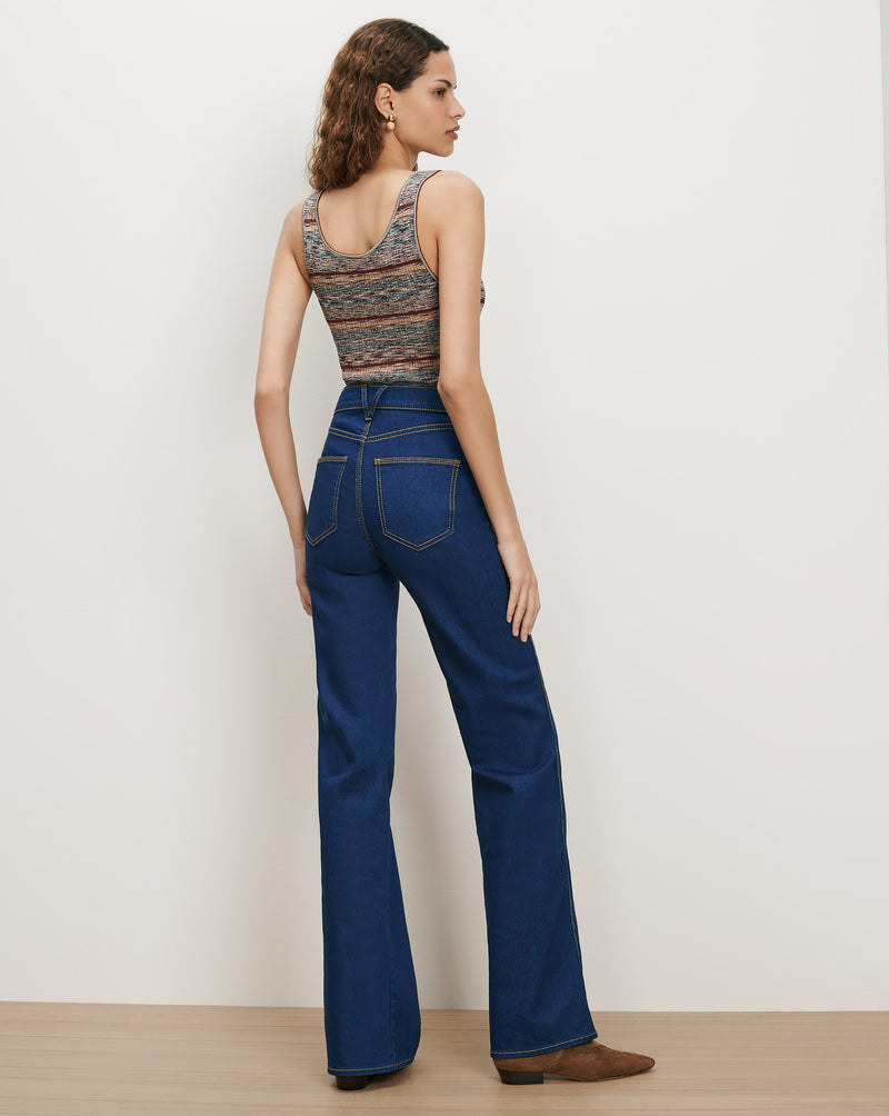 Veronica Beard Dark wash flared jeans and a striped knit tank top.