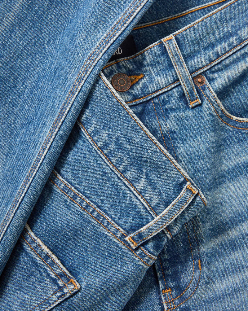 Veronica Beard Blue denim jeans with copper button and rivets.