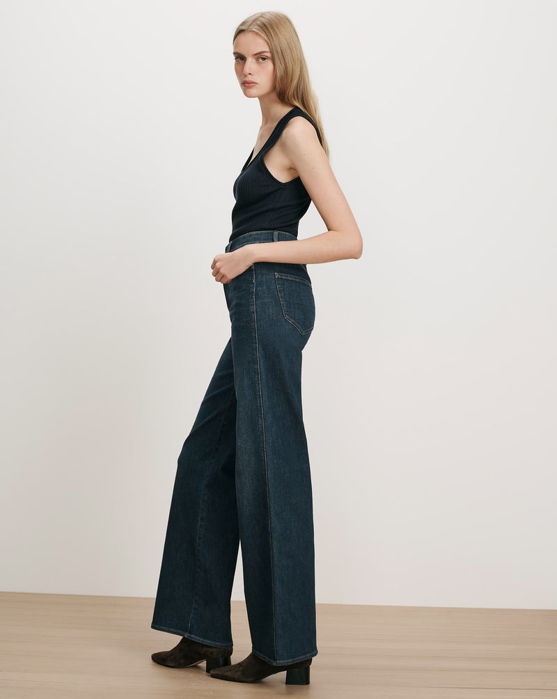 Veronica Beard Dark wash wide-leg jeans and black ribbed tank top.