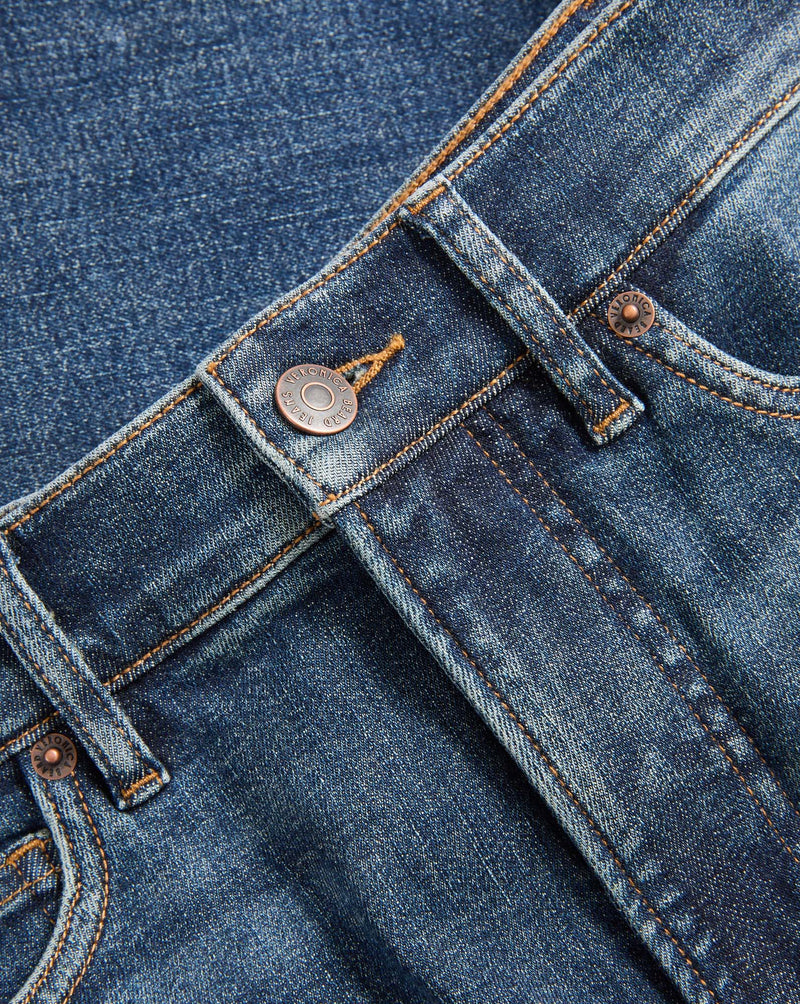 Veronica Beard Blue denim jeans with copper buttons and stitching.