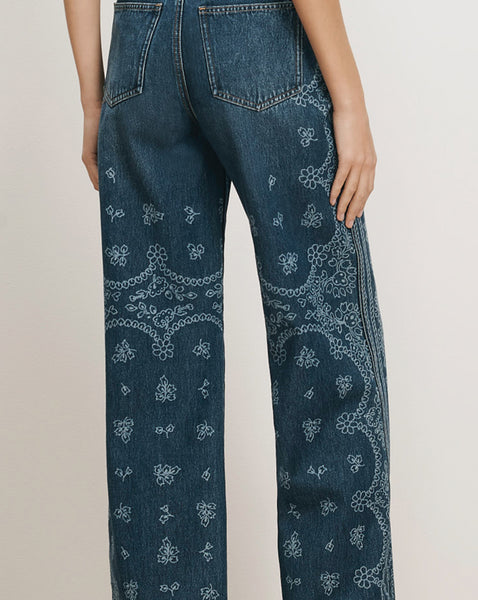 Veronica Beard Blue denim jeans with white floral embroidery.