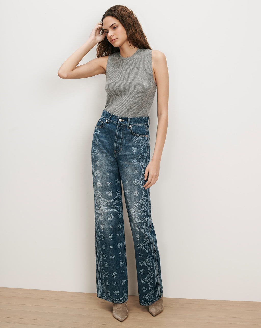 Veronica Beard Gray ribbed knit tank top, blue embroidered wide-leg jeans.