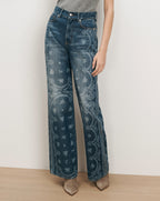 Veronica Beard Blue denim jeans with white floral embroidery.
