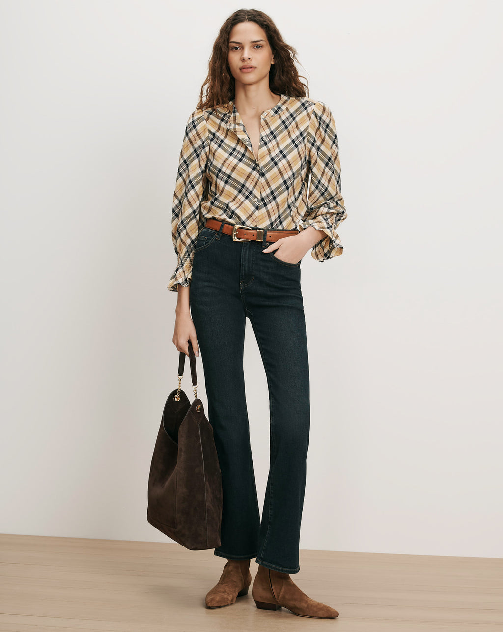 Veronica Beard Plaid button-up shirt, dark wash jeans, brown belt, brown suede bag.