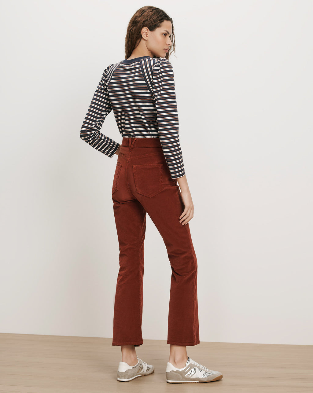 Veronica Beard Brown corduroy flared pants and striped long-sleeve shirt.