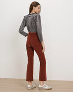 Veronica Beard Brown corduroy flared pants and striped long-sleeve shirt.