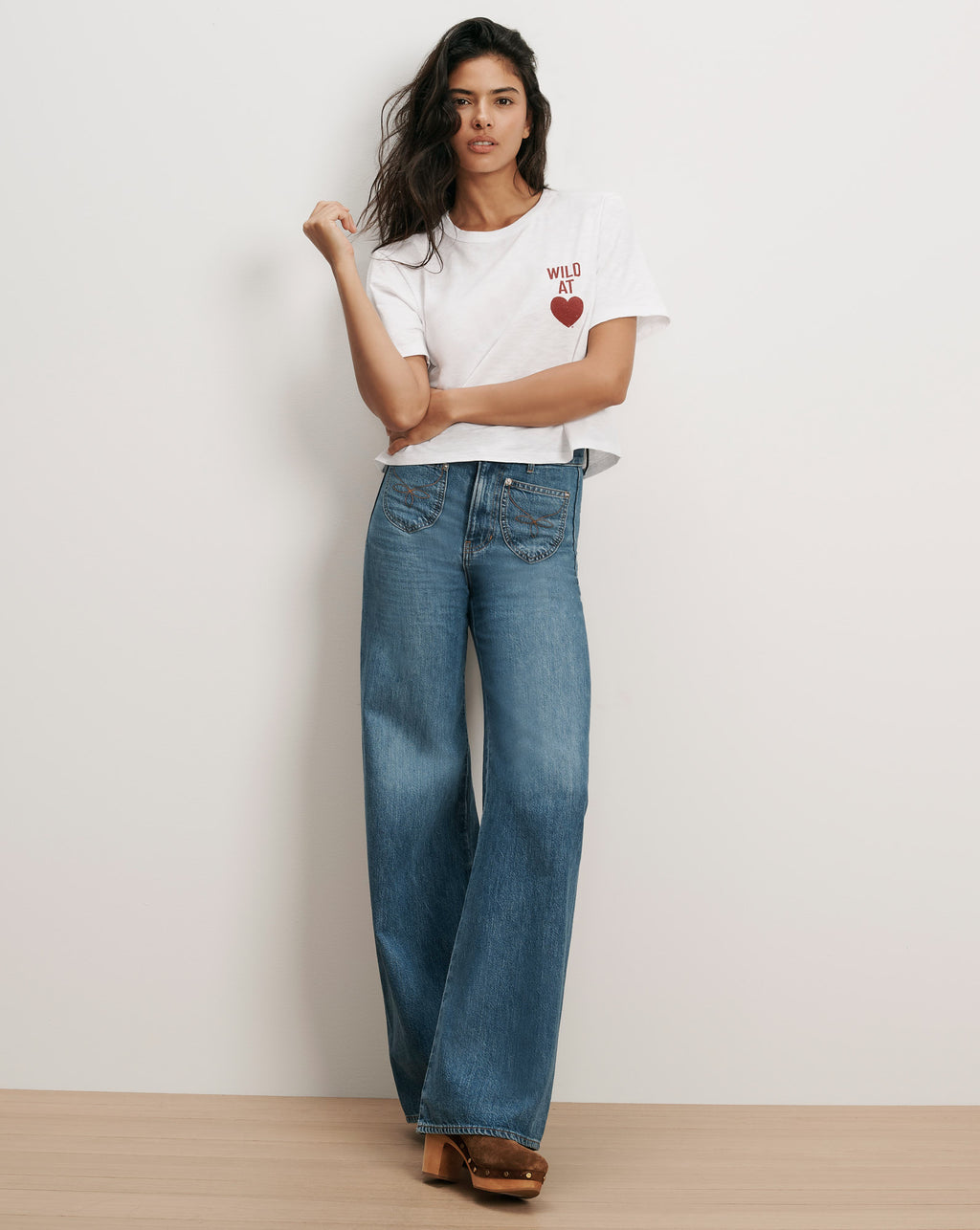 Veronica Beard White graphic tee and wide-leg jeans.