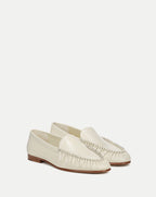 Veronica Beard Cream leather loafers with woven detail and rounded toe.