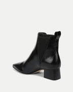 Veronica Beard Black patent leather Chelsea boots with block heel.