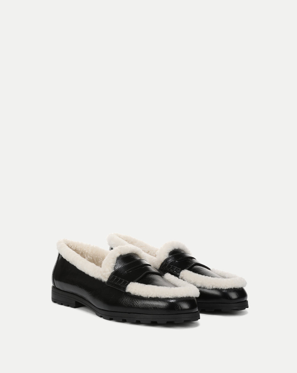 Veronica Beard Black leather loafers with white shearling trim.