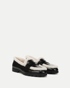 Veronica Beard Black leather loafers with white shearling trim.