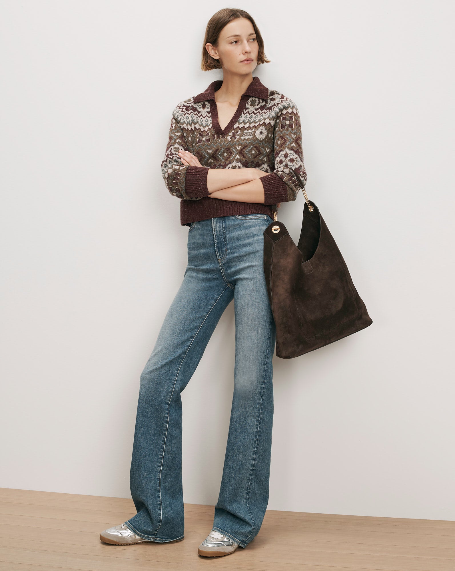 Veronica Beard Fair Isle sweater, blue flared jeans, brown suede bag.