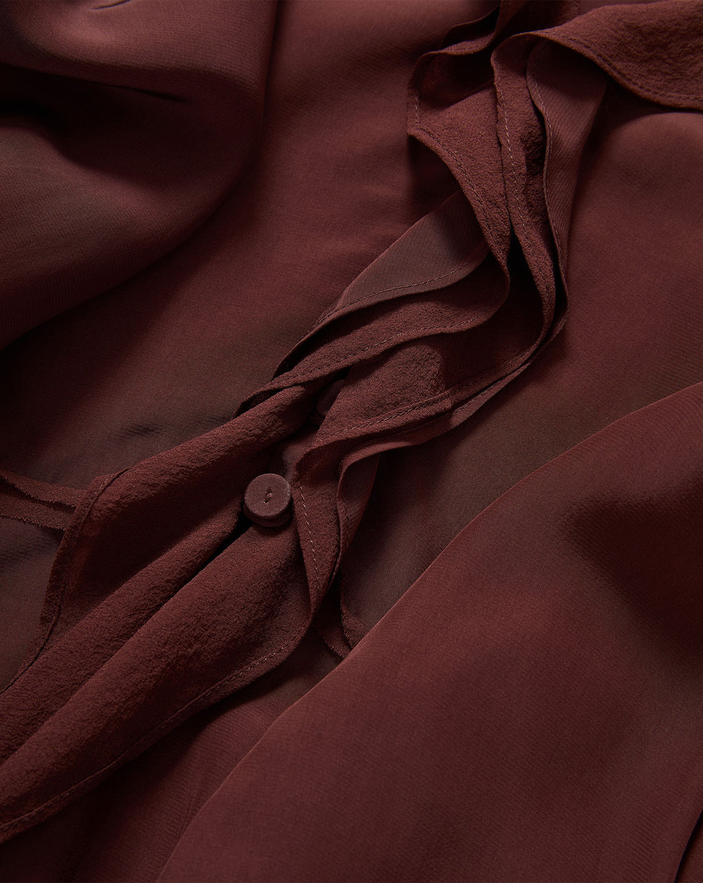 Veronica Beard Burgundy chiffon blouse with ruffled detailing and button.