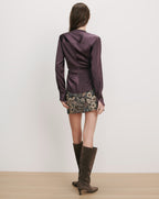 Veronica Beard Purple satin long-sleeve blouse and floral mini skirt.