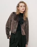 Veronica Beard Bronze sequin jacket, black turtleneck, and black trousers.