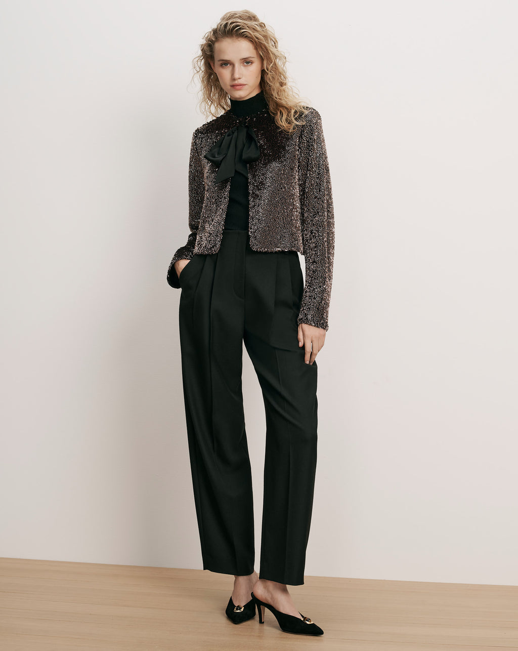 Veronica Beard Bronze sequin jacket, black turtleneck, black trousers, black heels.