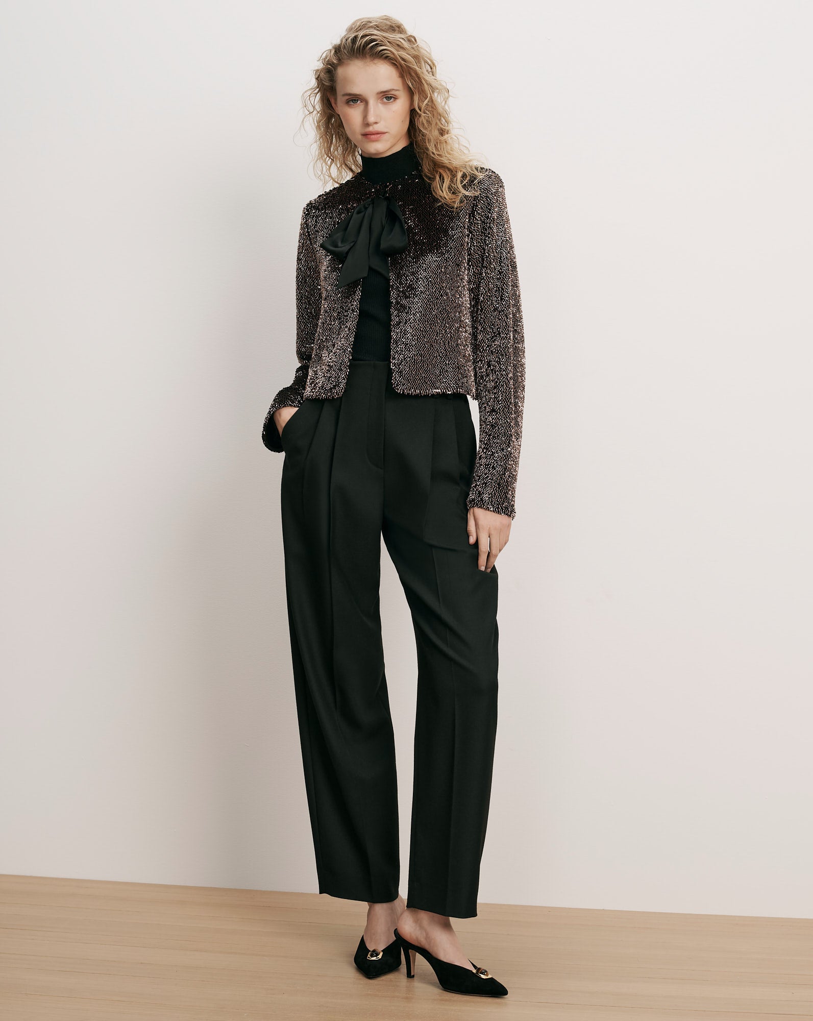 Veronica Beard Bronze sequin jacket, black turtleneck, black trousers, black heels.