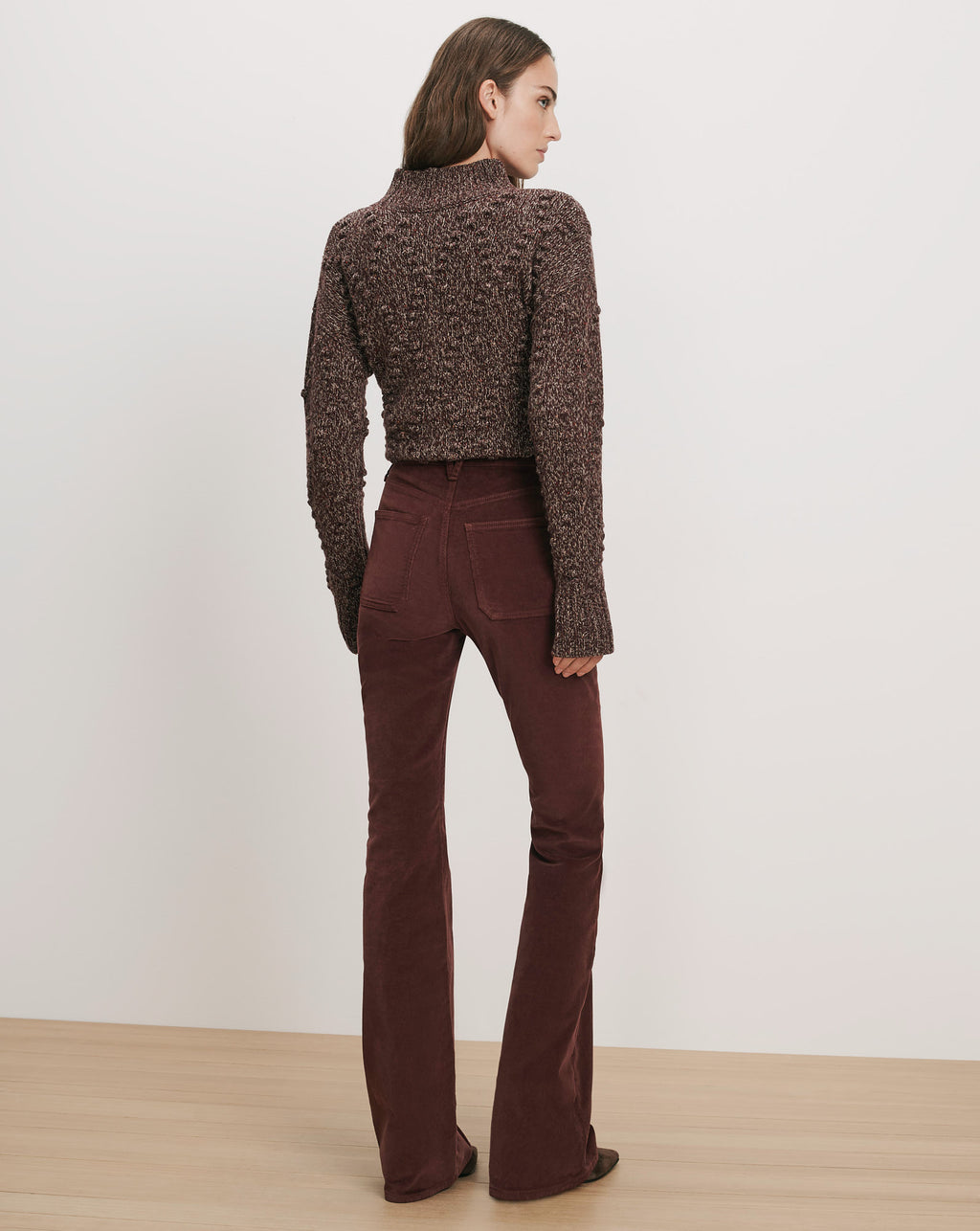 Veronica Beard Brown chunky knit sweater and burgundy corduroy flare pants.
